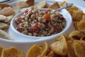 I first had this "mix" at my grandmother's house during a Christmas brunch and have not been able to break myself from taking this quick and easy snack for multiple parties I attend from time to time...Yup! You all now know why I am so happy you when you request me to make this dish. 1, 11oz can white shoe peg corn 1, 15oz can garbonzo beans 1, 15oz can black eye peas 1, 10oz can rottelle,  1 tbsp garlic salt 1 tbsp onion powder 1 tsp parsley 1 tsp basil 1 tsp rosemary salt and pepper to taste Strain garbonzo beans, black eye peas, corn, and rotelle; add to a large mixing bowl.  Add garlic salt, onion powder, parsley, basil, rosemary, salt and pepper and stir thoroughly.  Place in refrigerator for a few hours to allow seasonings to marinate. When serving, let stand at room temperature for about 20 minutes.  I like to serve this with fritos or homemade thin bagel chips.  For bagel chips, toast in toaster and then cut into triangles.  You're now ready to Serve!!!!