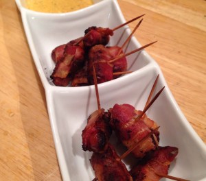 Bacon Wrapped Smokies: 10 slices of center cut bacon 30 Hillshire farm smokies 30 toothpicks Preheat oven to 375 degrees.  Cut the each slice of bacon into thirds/3 equal squares.  Using once square of bacon, wrap it around once smokie and secure with a toothpick.  Complete this process until all pieces of bacon and smokies are used.  Place the bacon wrapped smokies on a non-stick cookie sheet and bake for 15 minutes.  After 15 minutes, flip the smokies over and cook for another 15 minutes.  Yes...That simple...That easy....and sooooo delicious. **I made a "honey-mustard" sauce to go with ours.  I use the term honey-mustard very, VERY loosely, as I do not like a really sweet honey-mustard and Chris does not like a lot of mustard.  The recipe for the "honey-mustard" is listed below.** Honey-Mustard Dipping Sauce: 3 tbsp Mayonnaise 1 tbsp mustard 1 tsp honey 1.5 tsp chili powder Mix all ingredients together until sauce is well blended.  I must say, these measurements may not be exact because I kept adding mayonnaise and chili powder to dilute the honey.  For this, use your best judgement...AKA...your own tastebuds :)