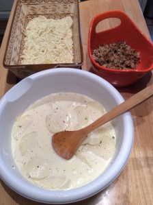 Potatoes: 8 medium red potatoes, peeled and sliced 1/8 of an inch 2 c heavy cream 3 bay leaves 1 Full sprig of fresh rosemary 1.5 tbsp minced garlic 1 tbsp parsley 3 tbsp butter salt and pepper 1.5 c mozzarella 1/3 c parmesan Preheat oven to 425 degrees.  Peel and slice red potatoes an 1/8 inch and place in a large bowl.  In a sauce pan, bring heavy cream, bay leaves, rosemary, parsley, garlic, parsley, and 2 tbsp butter to a simmer.  Once the cream has simmered for about 3-5 minutes over medium heat, add the mixture to the bowl with the potatoes.  Remove the bay leaves and rosemary.  Add the cooked chicken and coat potatoes and chicken with the heavy cream mixture.   Coat a large baking dish with 1 tbsp of butter.  Layer potatoes to coat the bottom of the baking dish.  Add some of the meat and then a little bit of the mozzarella.  Repeat these steps until all potato slices and meat have been used.  Pour the rest of the cream throughout the entire mixture and top with the parmesan cheese.  Cover with aluminum foil and cook for 45 minutes, leaving a corner of the aluminum foil open in order for some of the steam to be released.  Uncover and cook for an additional 15 minutes or until top has browned.  ***It took mine a little longer to cook because I baked the dish at 400 degrees.  I highly recommend cooking it at 425 degrees for 45 minutes, removing the foil, and using your own discretion as to how brown you would like the dish.*** Hope you enjoy as much as we did!!! :-)